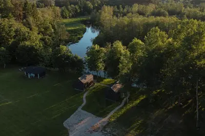 an aerial view of a cabin and a lake at Rest Green in Degesiai