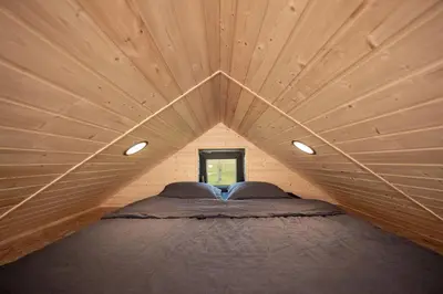 a room with a bed in a wooden house at Rest Green in Degesiai