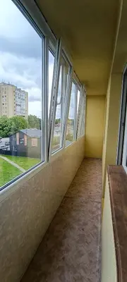 an empty room with windows in a building at Adelės Apartamentai Panevėžyje in Panevėžys