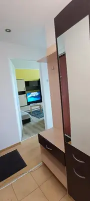 a living room with a dresser and a mirror at Adelės Apartamentai Panevėžyje in Panevėžys