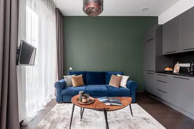 a living room with a blue couch and a table at Vilnius Old Town Renaissance Studio 2 in Vilnius