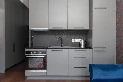 a kitchen with white cabinets and a sink at Vilnius Old Town Renessainse Studio 3 in Vilnius