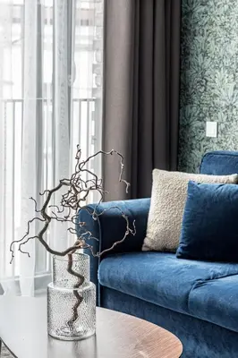 a living room with a blue couch and a table at Vilnius Old Town Renessainse Studio 4 in Vilnius