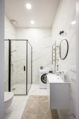 a white bathroom with a shower and a sink at Vilnius Old Town Renessainse Studio 4 in Vilnius