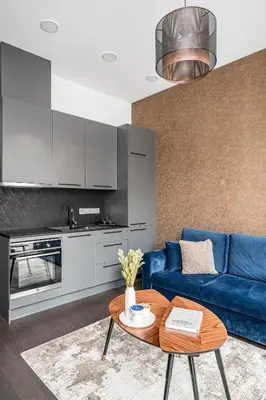 a living room with a blue couch and a table at Vilnius Old Town Renessainse Studio 4 in Vilnius