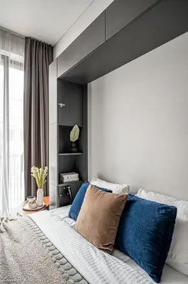 a bedroom with a large bed with blue pillows at Vilnius Old Town Renessainse Studio 4 in Vilnius