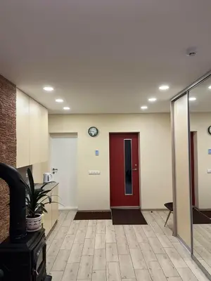 an office lobby with a red door and a clock at LIUX apartamentai in Kaunas