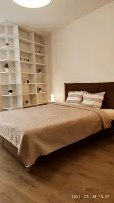 a bedroom with a large bed with white shelves at HaPPy Inn Egle, Self Check-In-24-7, A-C, Parking-in-the-underground-Garage in Vilnius