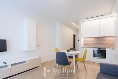 a kitchen and dining room with a table and chairs at HaPPy Inn Egle, Self Check-In-24-7, A-C, Parking-in-the-underground-Garage in Vilnius