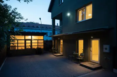 a courtyard of a house with a building at Villa ACACIA in Kaunas