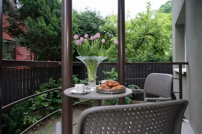 a table with a vase of tulips and a basket of croissants at Villa ACACIA in Kaunas