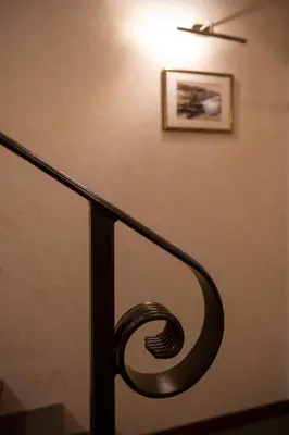 a stair railing with a picture on the wall at Villa ACACIA in Kaunas