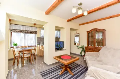 a living room with a couch and a table at Žemyna Apartmentai in Druskininkai