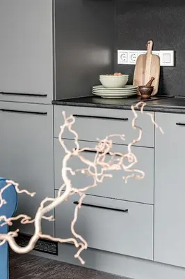 a kitchen with white cabinets with a painting on it at Vilnius Old Town Studio Renessaince 5 in Vilnius