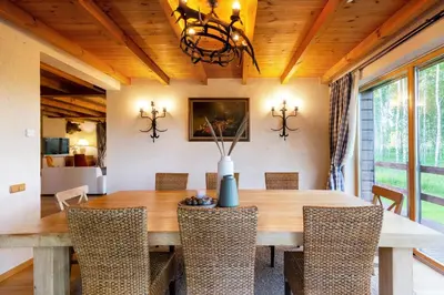 a dining room with a wooden table and chairs at Friends & Family Getaway to Forest House by Reside Baltic in Samaka