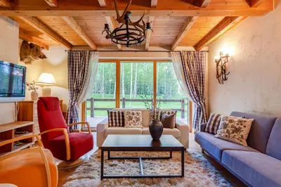 a living room with a couch and a table at Friends & Family Getaway to Forest House by Reside Baltic in Samaka