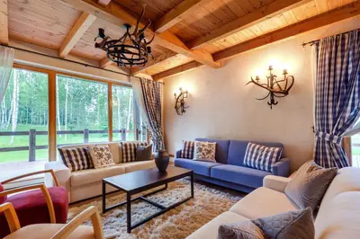 a living room with couches and a table at Friends & Family Getaway to Forest House by Reside Baltic in Samaka