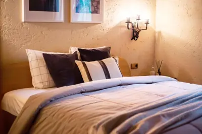 a bedroom with a bed with pillows on it at Friends & Family Getaway to Forest House by Reside Baltic in Samaka