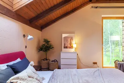 a bedroom with a bed and a window at Friends & Family Getaway to Forest House by Reside Baltic in Samaka