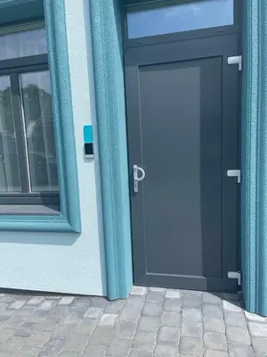 a blue door of a building with a window at Editos apartamentai in Jurbarkas