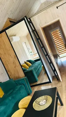 a tiny house with a couch and a table at Chill House in Anykščiai