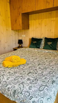 a bed with two yellow towels on top of it at Chill House in Anykščiai