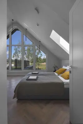 a white bedroom with a large bed and large windows at MINDAUGO VILOS in Piliuona