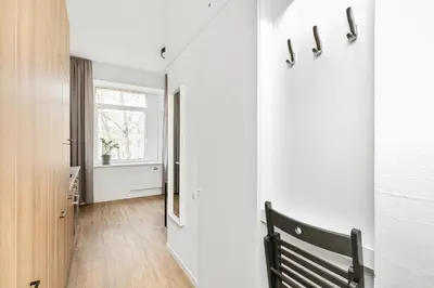 a hallway with a bench and a window at Air Apartments - Code entry only, No staff in Vilnius