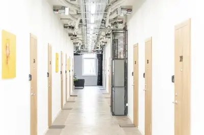 an empty hallway in an office with white walls and doors at Air Apartments - Code entry only, No staff in Vilnius