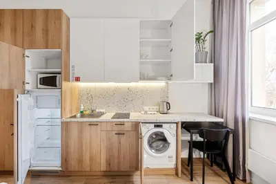 a kitchen with a washing machine and a washer at Air Apartments - Code entry only, No staff in Vilnius