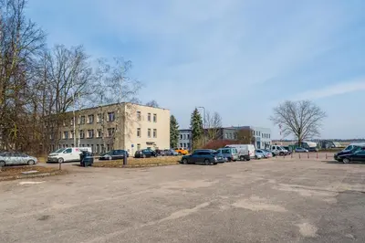 a parking lot with cars parked in front of a building at Air Apartments - Code entry only, No staff in Vilnius
