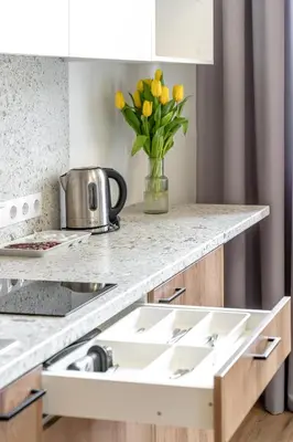 a kitchen with a sink and a vase of yellow tulips at Air Apartments - Code entry only, No staff in Vilnius