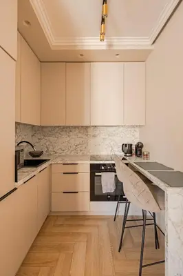 a kitchen with white cabinets and a table and chairs at TOP located NEW Stylish apartment in Vilnius Old Town in Vilnius