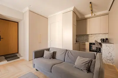 a living room with a couch and a kitchen at TOP located NEW Stylish apartment in Vilnius Old Town in Vilnius
