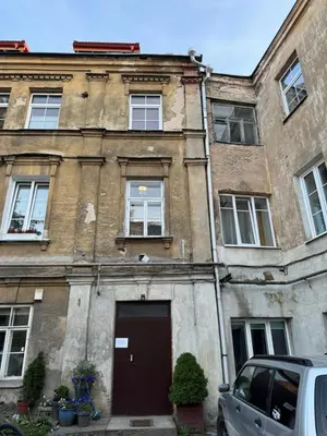an old brick building with a door in front at TOP located NEW Stylish apartment in Vilnius Old Town in Vilnius