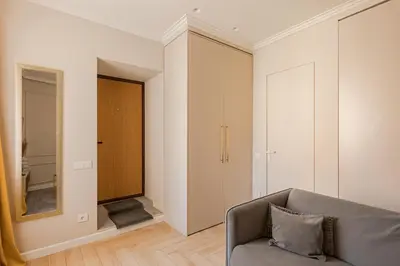 a living room with a couch and a mirror at TOP located NEW Stylish apartment in Vilnius Old Town in Vilnius