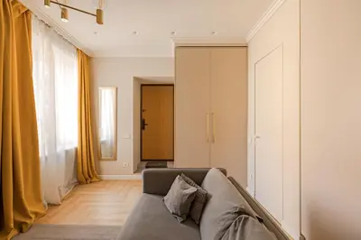 a living room with a couch and yellow curtains at TOP located NEW Stylish apartment in Vilnius Old Town in Vilnius
