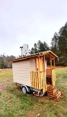 a tiny house on the back of a truck in a field at Glamping in - luxury tent in Šunupis