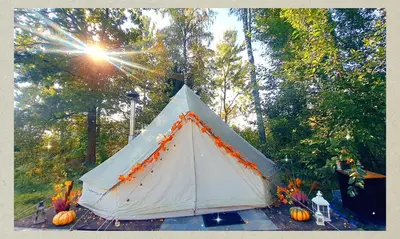 a white tent with pumpkins on the ground at Glamping in - luxury tent in Šunupis