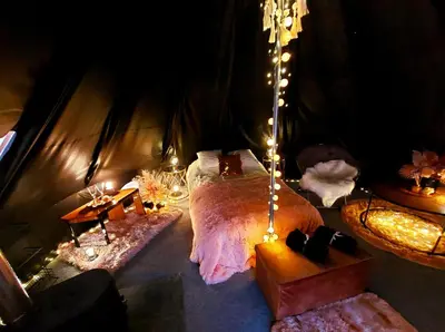 a room with a bed in a tent with lights at Glamping in - luxury tent in Šunupis