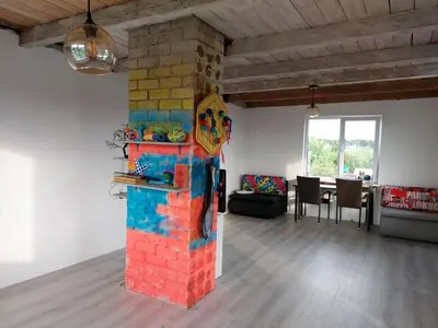 a living room with a brick wall and a table at Namas su terasa in Vilnius
