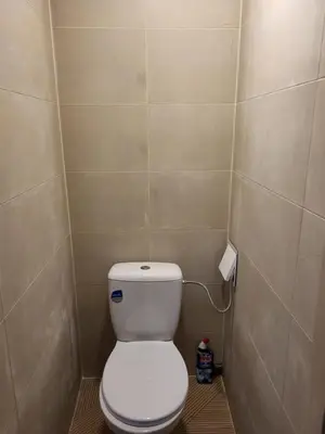 a bathroom with a white toilet in a stall at Namas su terasa in Vilnius