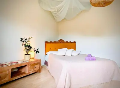 a bedroom with a large white bed and a table at Three bedroom with two terraces for 7people+baby in Kaunas