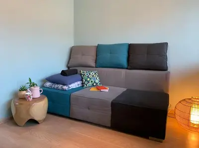 a living room with a couch and a table at Three bedroom with two terraces for 7people+baby in Kaunas