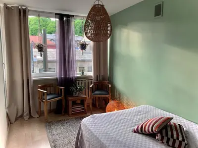 a bedroom with a bed and a large window at Three bedroom with two terraces for 7people+baby in Kaunas