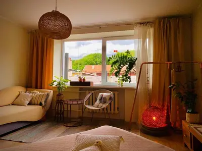 a living room with a couch and a window at Three bedroom with two terraces for 7people+baby in Kaunas