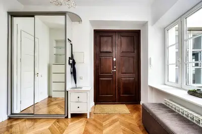 a mirror in a living room with a brown door at Old town, Bright, Peaceful, Balcony, Netflix in Vilnius