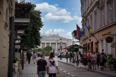 a group of people walking down a city street at Old town, Bright, Peaceful, Balcony, Netflix in Vilnius