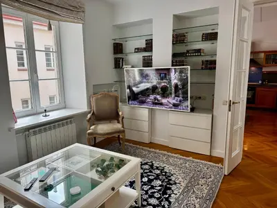 a living room with a tv and a chair at Old town, Bright, Peaceful, Balcony, Netflix in Vilnius