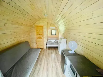 a large wooden room with a bed in a room at Palūšės Kempingas (nameliai) in Palūšė